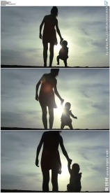 母亲牵着婴儿走路