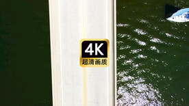 航拍游艇经过跨海大桥下