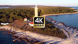 航拍海浪冲击礁石岸边灯塔