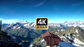 航拍雪山顶上红色房屋